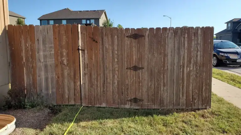 Dirty gray wood fence before cleaning