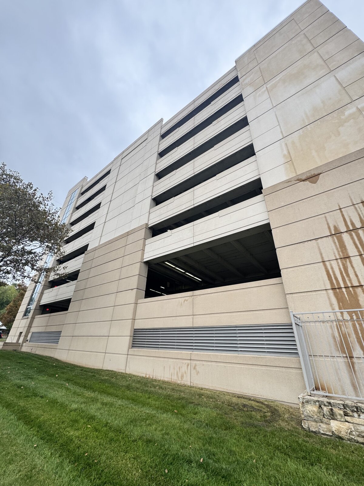 High-rise parking garage exterior building cleaning after KC Splash — clean uniform concrete facade Kansas City commercial building washing result