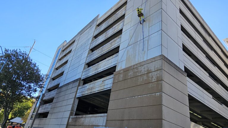 Heart of America rope-access technician descending a high-rise exterior in Kansas City with KC Splash
