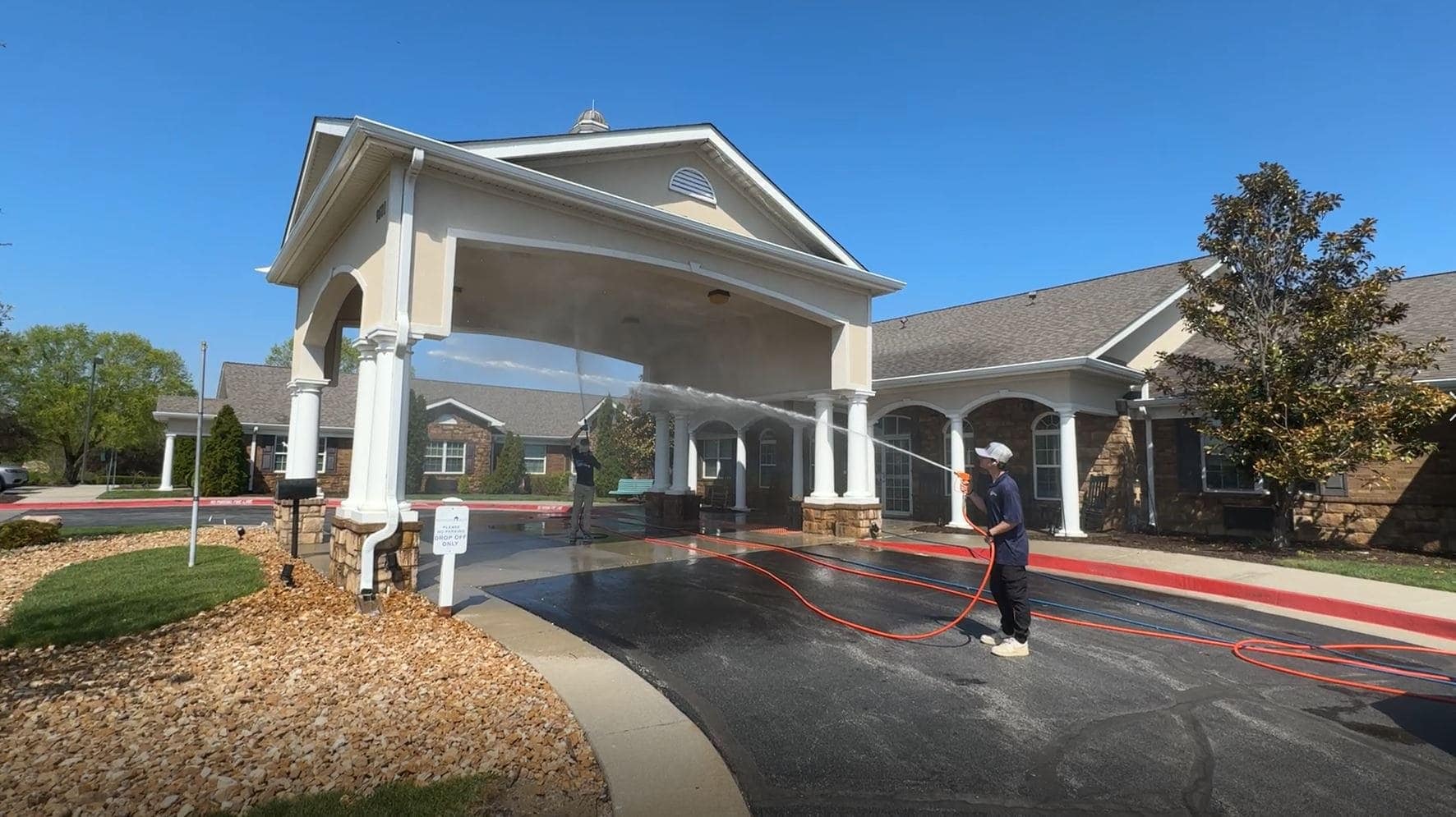 KC Splash commercial pressure washing at a business entrance in Grandview, MO