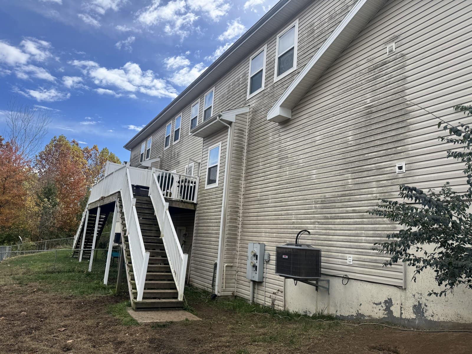 Fort Leavenworth military housing duplex before soft wash cleaning — heavy algae and mold staining visible on vinyl siding Fort Leavenworth Kansas