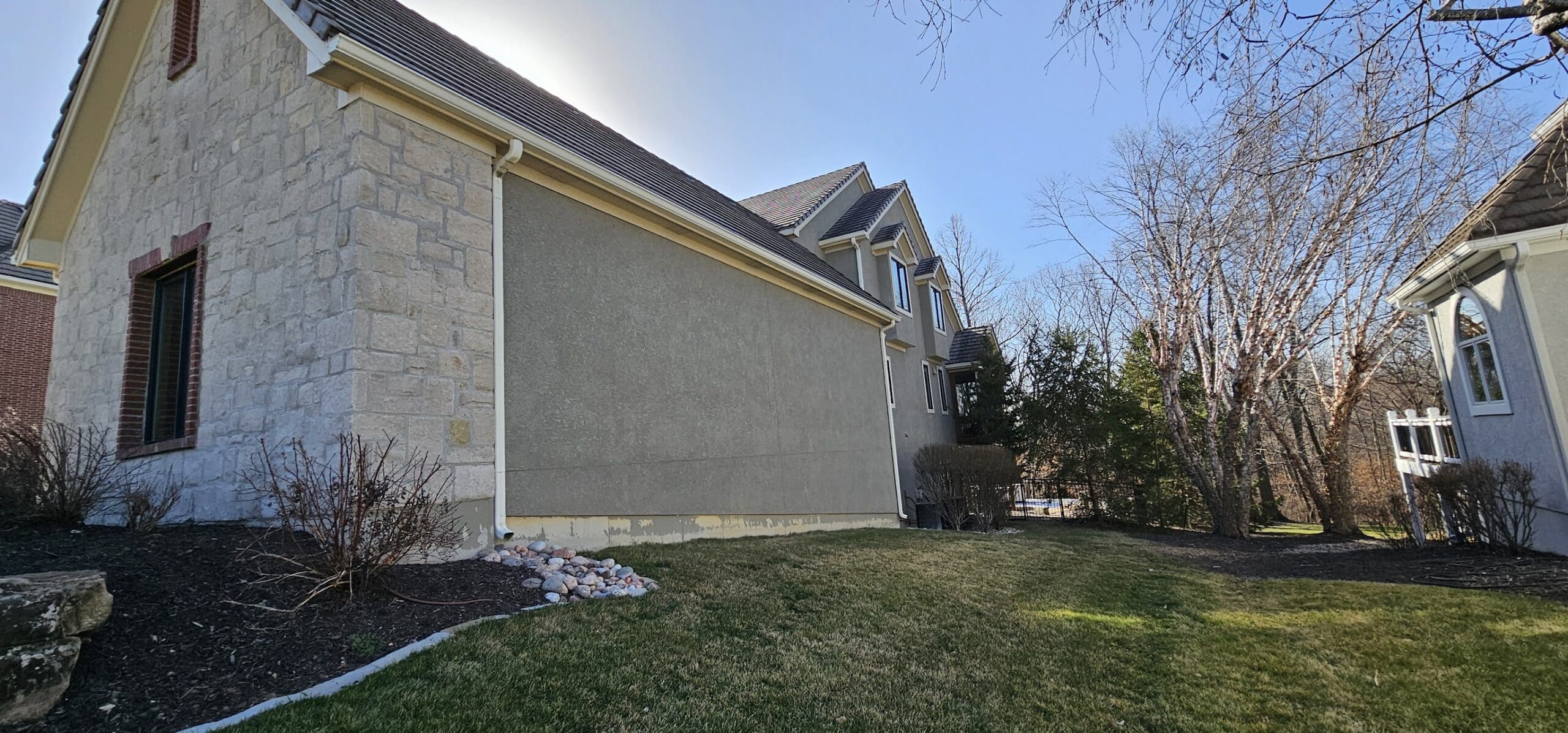 Luxury stone and stucco home with large driveway in Riss Lake Parkville MO