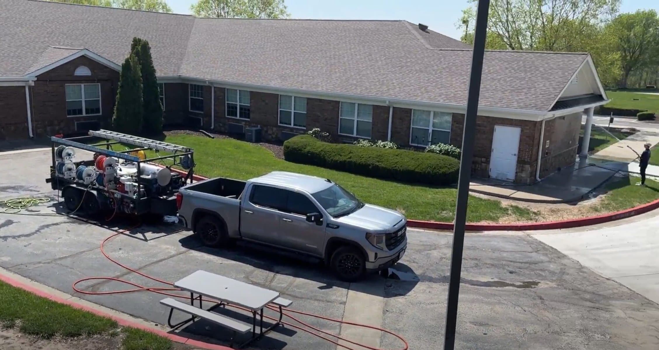 KC Splash crew soft washing the main entry at Addington Place of Shoal Creek Kansas City blue sky