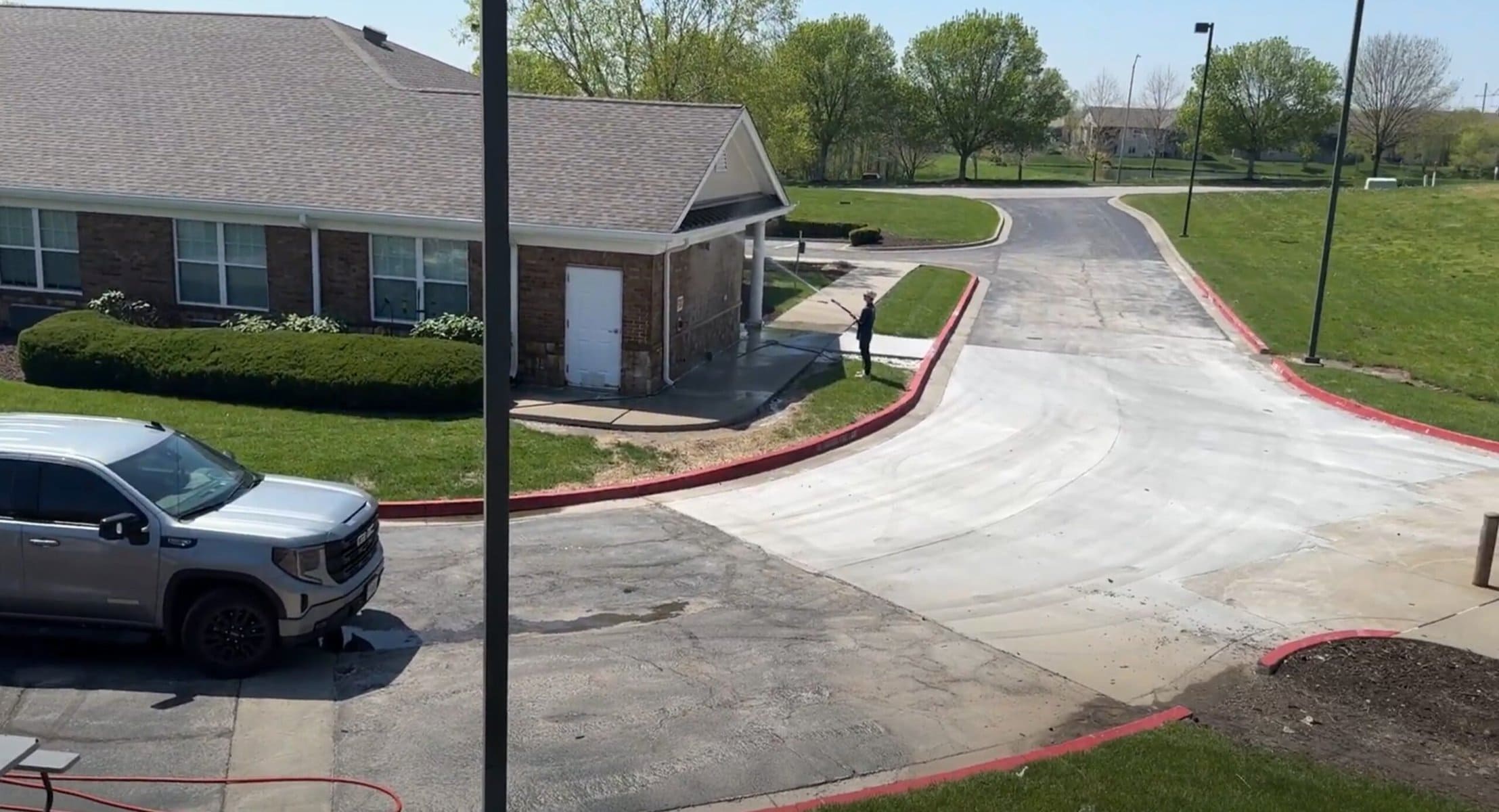 Aerial view β KC Splash crew member pressure washing sidewalk at Addington Place Shoal Creek Kansas City
