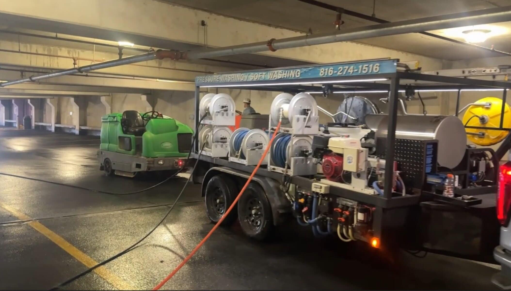 KC Splash pressure washing rig and ride-on scrubber staged inside Crown Center garage