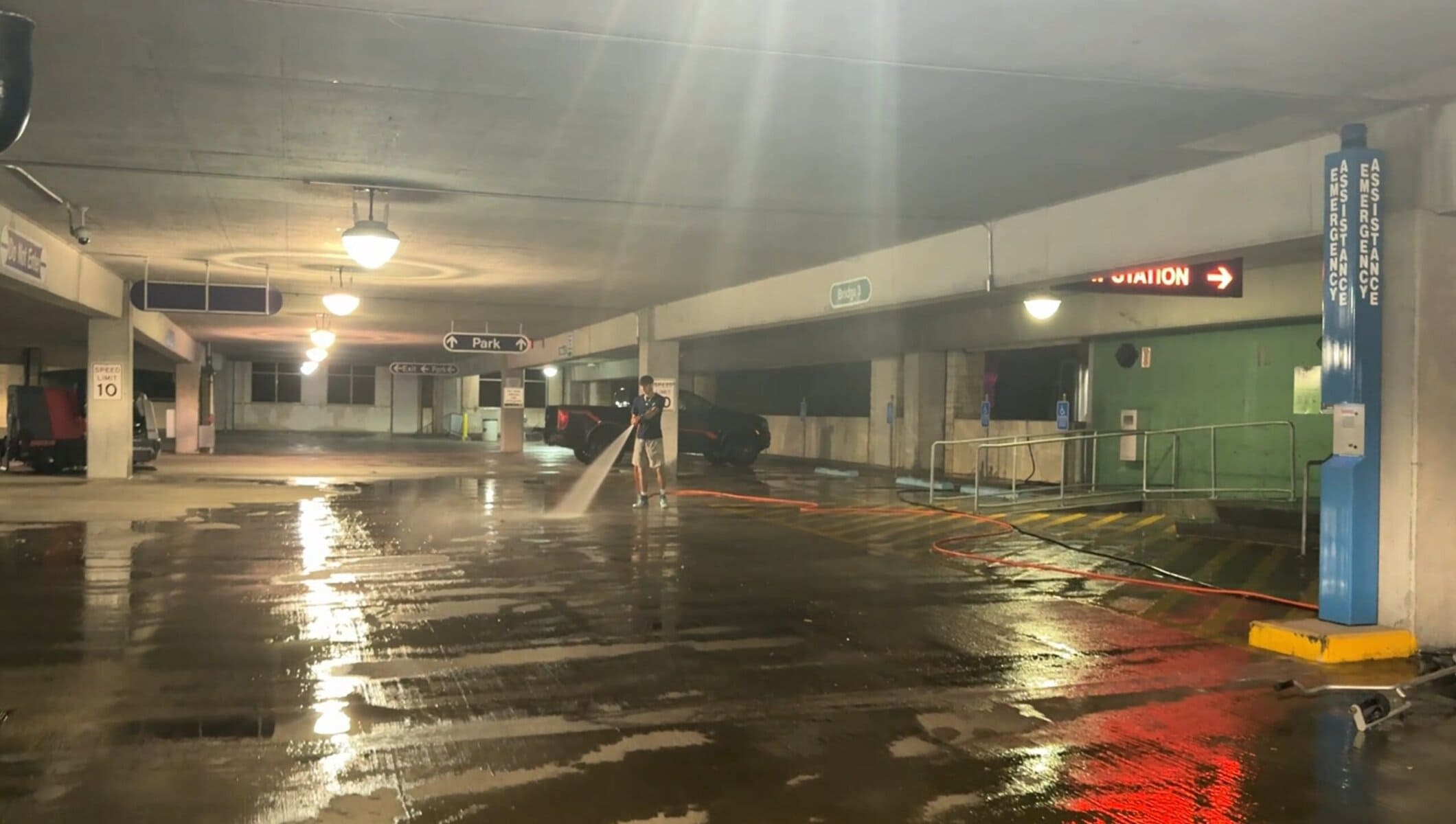 Crown Center parking garage cleaning Kansas City at night — Park signs atmospheric wide shot