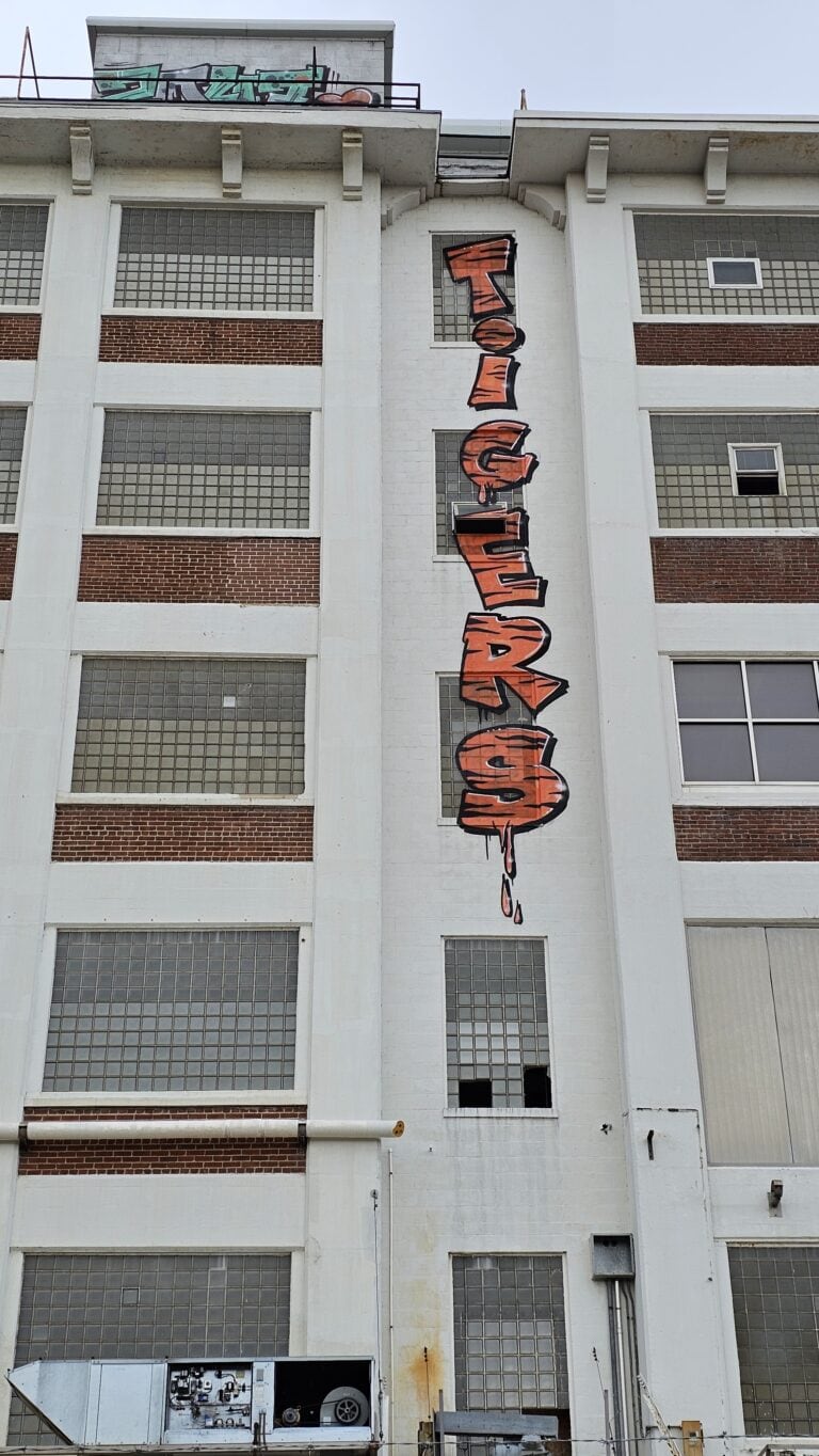Heavy graffiti tagging on a Kansas City building before removal