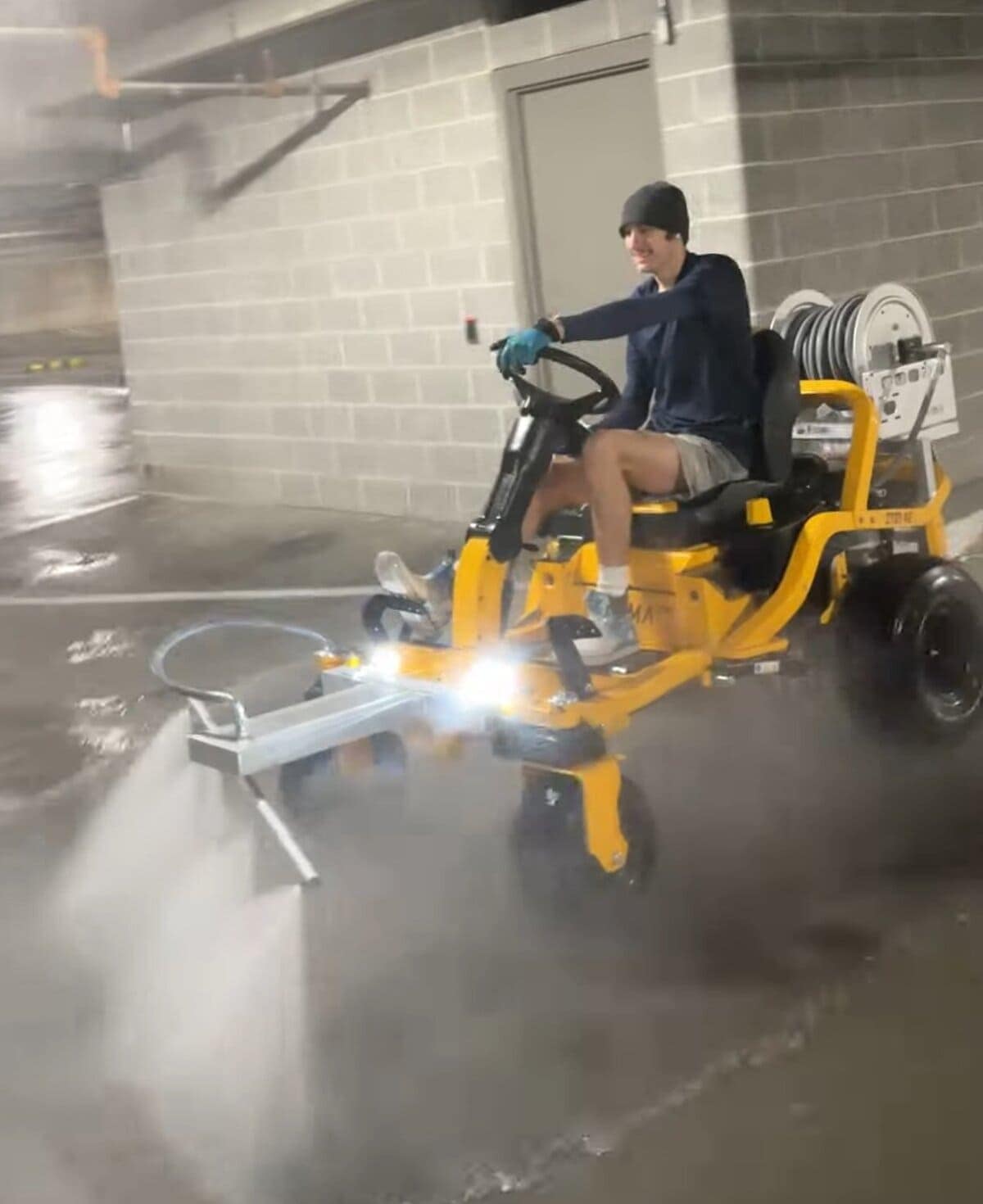 The Beast ride-on surface cleaner at full speed inside the Kansas City Public Library parking garage structure