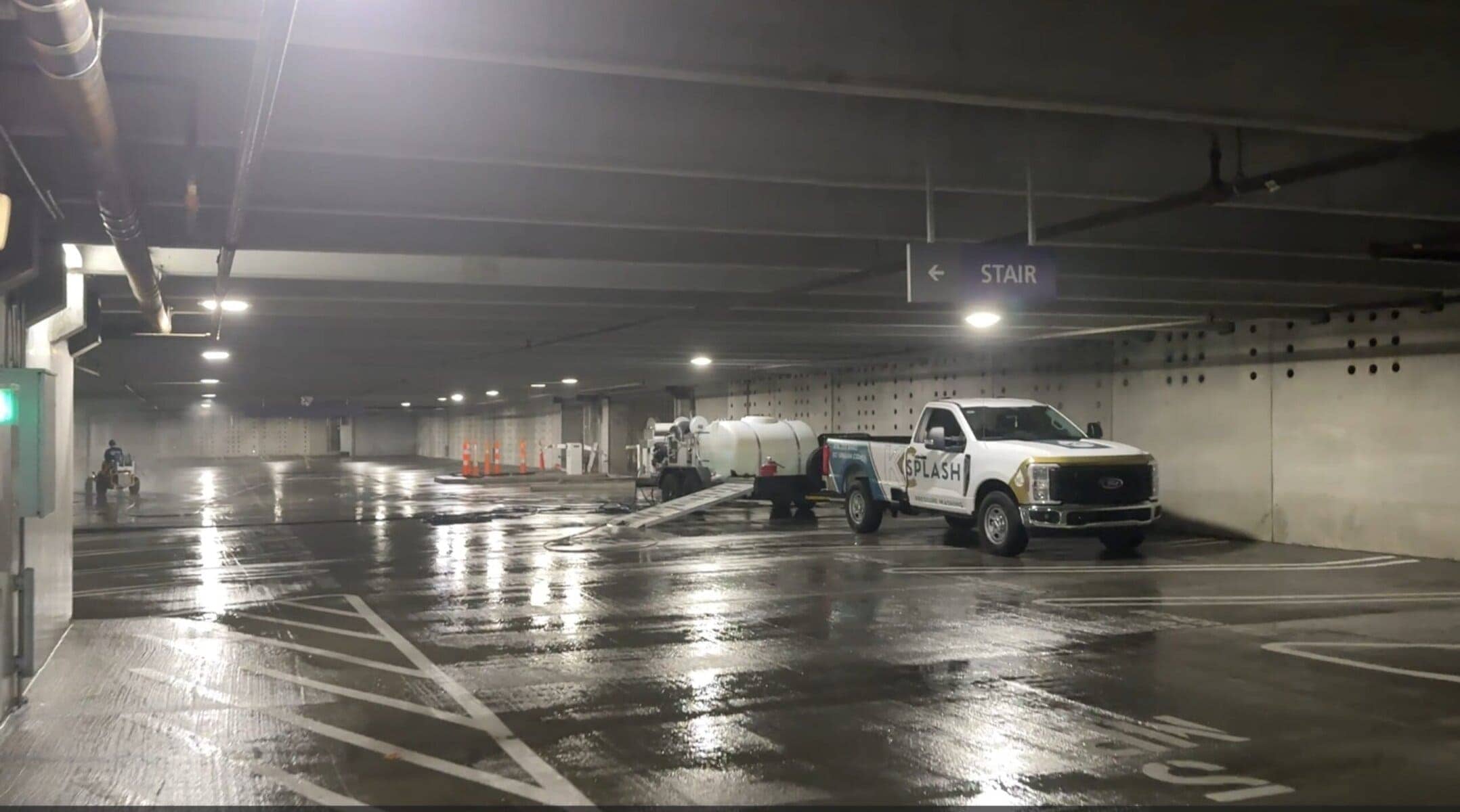 KC Splash commercial trucks and water trailers staged inside a major parking deck system