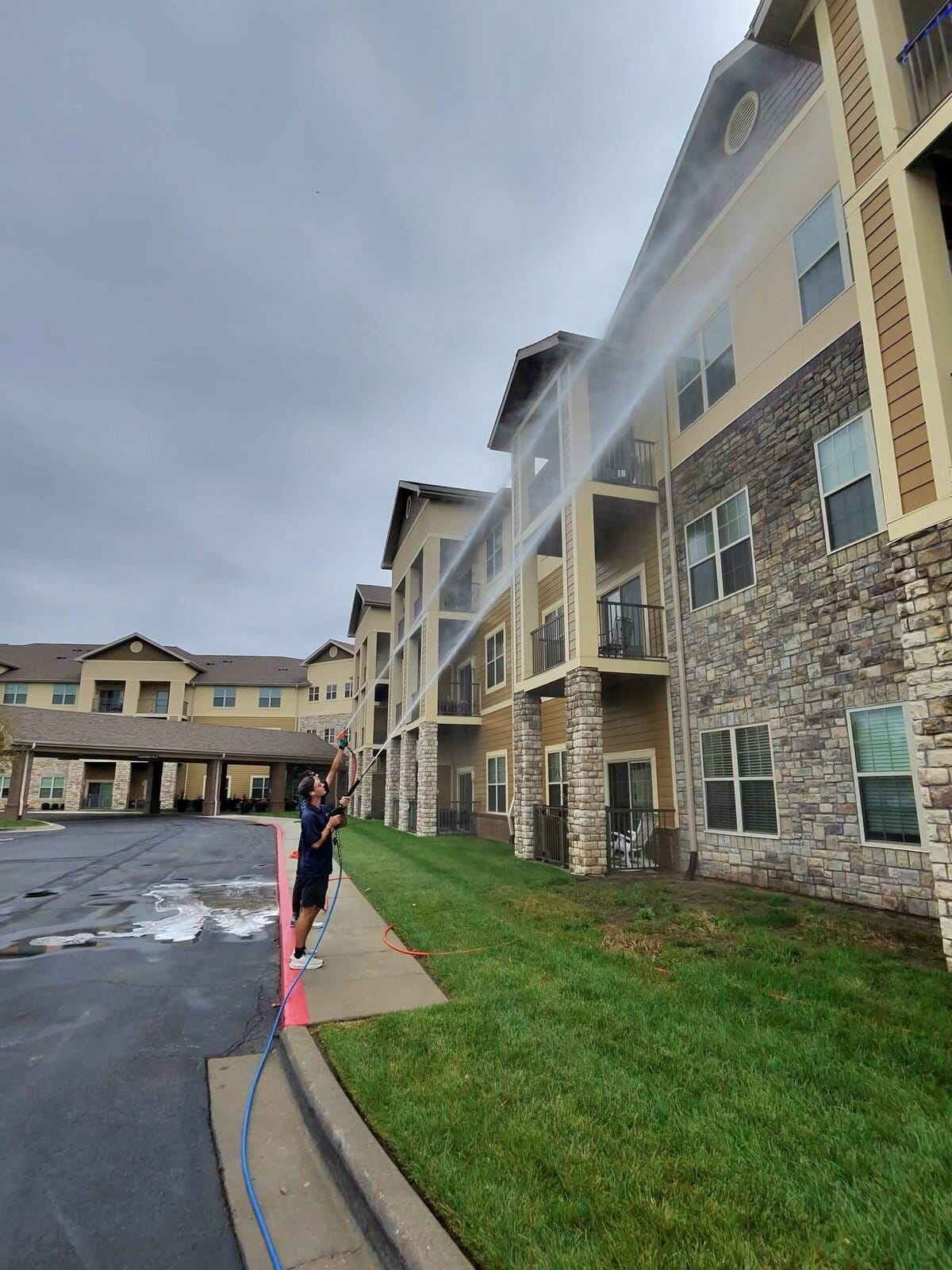 KC Splash crew soft washing exterior of senior living building Blue Springs Missouri