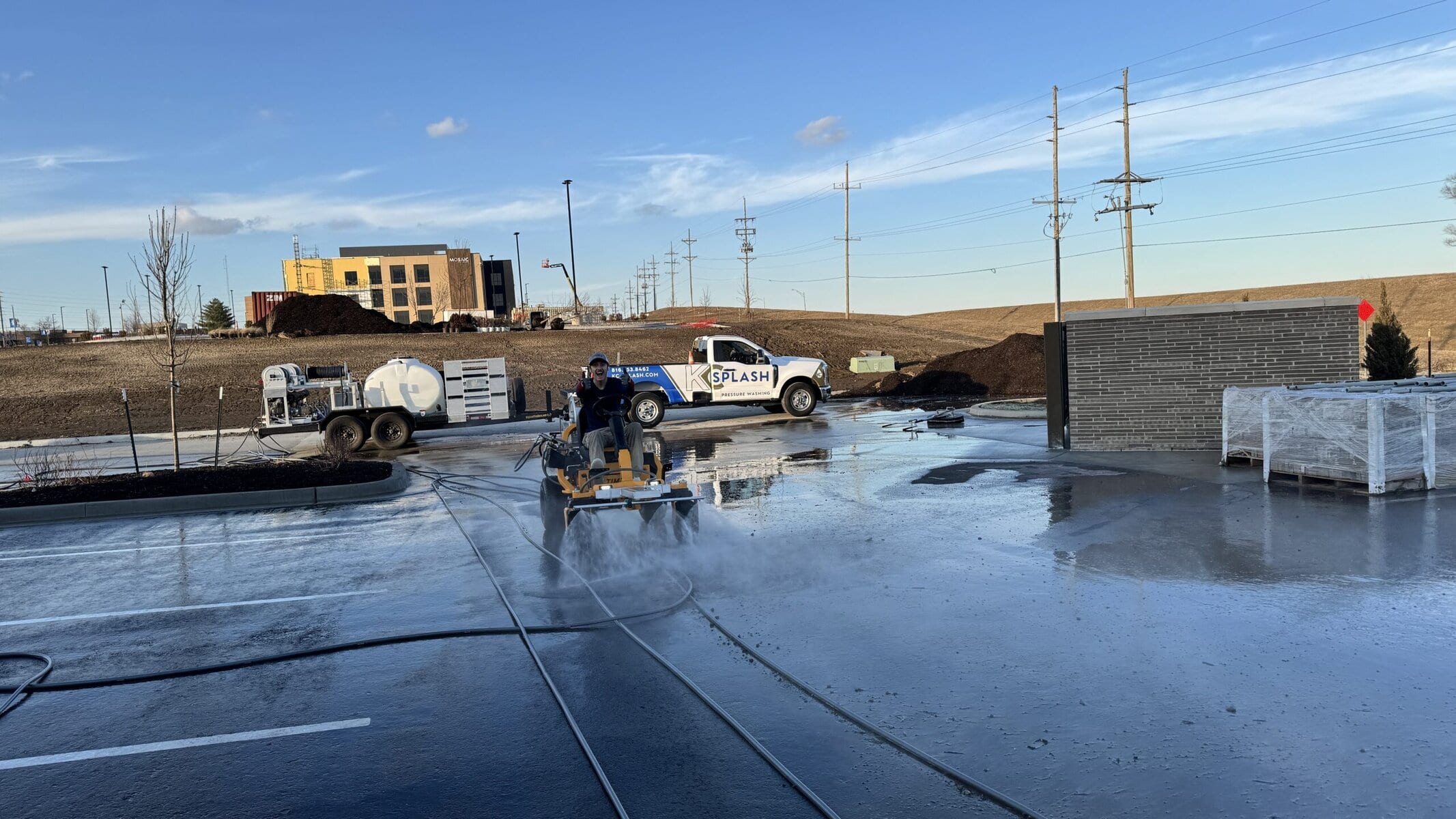 KC Splash branded truck and Beast ride-on surface cleaner at Rolling Hills Library post-construction parking lot cleanup St. Joseph Missouri
