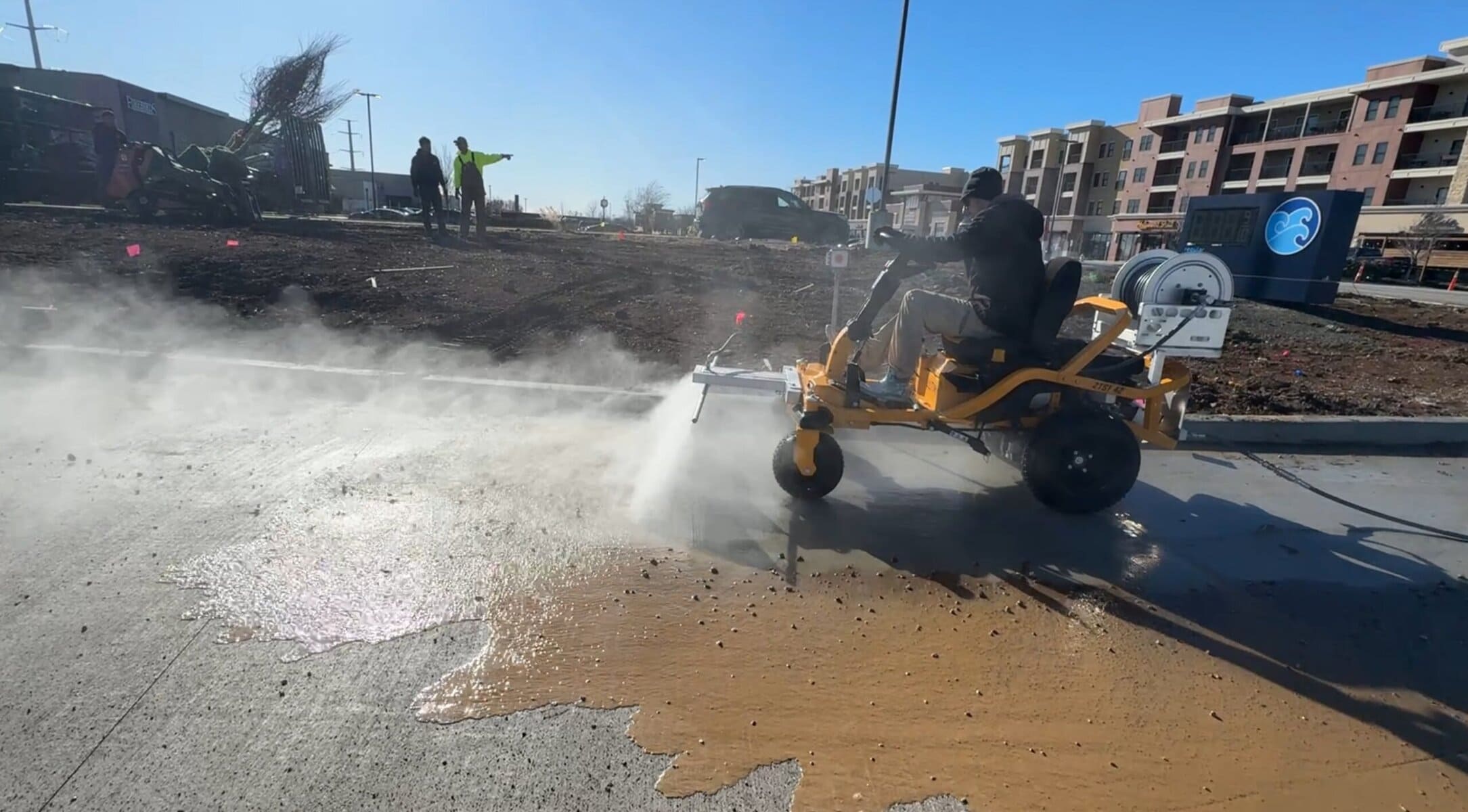 The Beast ride-on surface cleaner running the full length of Tidal Wave Auto Spa car wash tunnel during post-construction cleaning