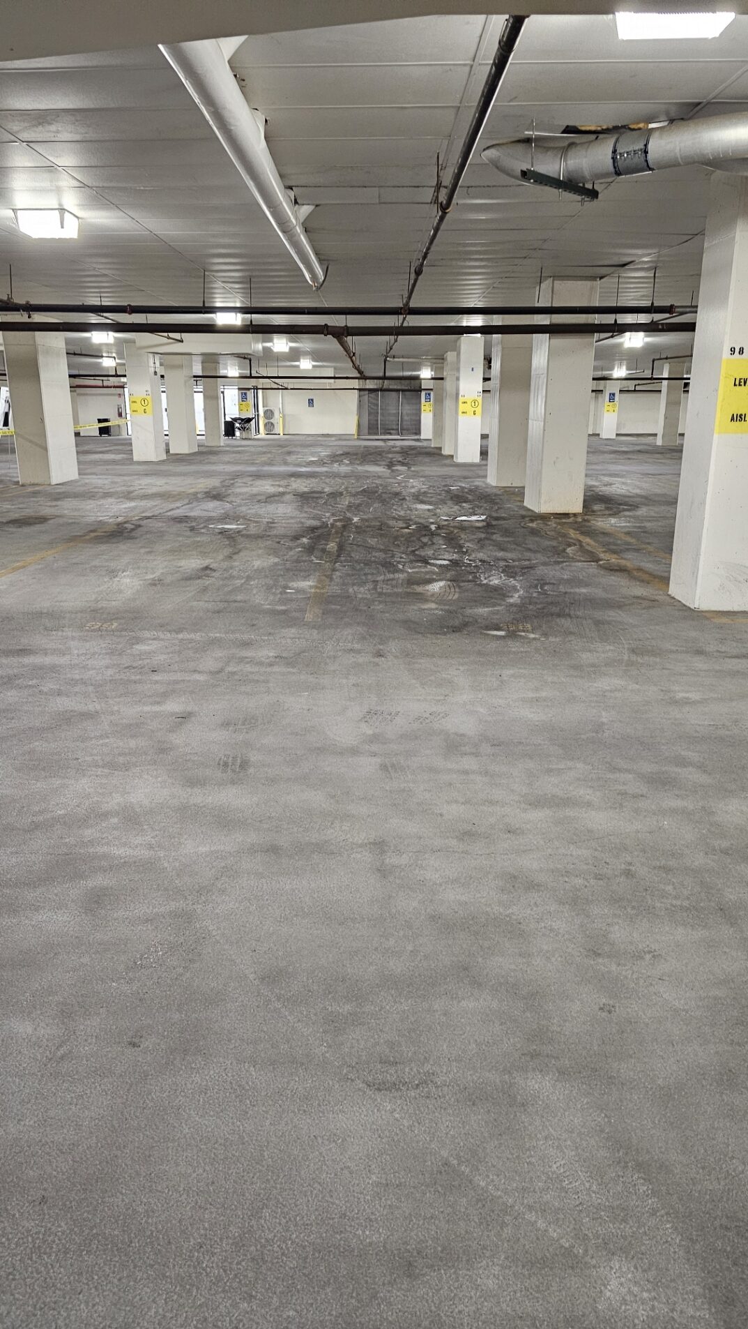 Close-up of deep oil residues embedded on parking structure concrete floor