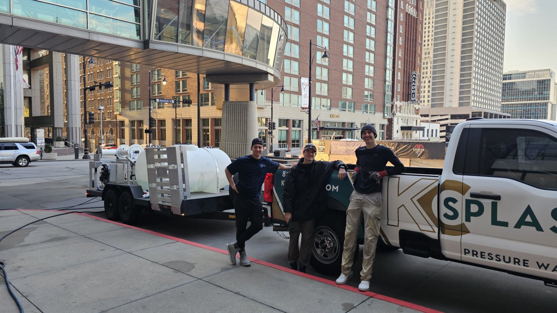 KC Splash three-man crew with pressure washing truck after completing Marriott Downtown Kansas City parking garage job