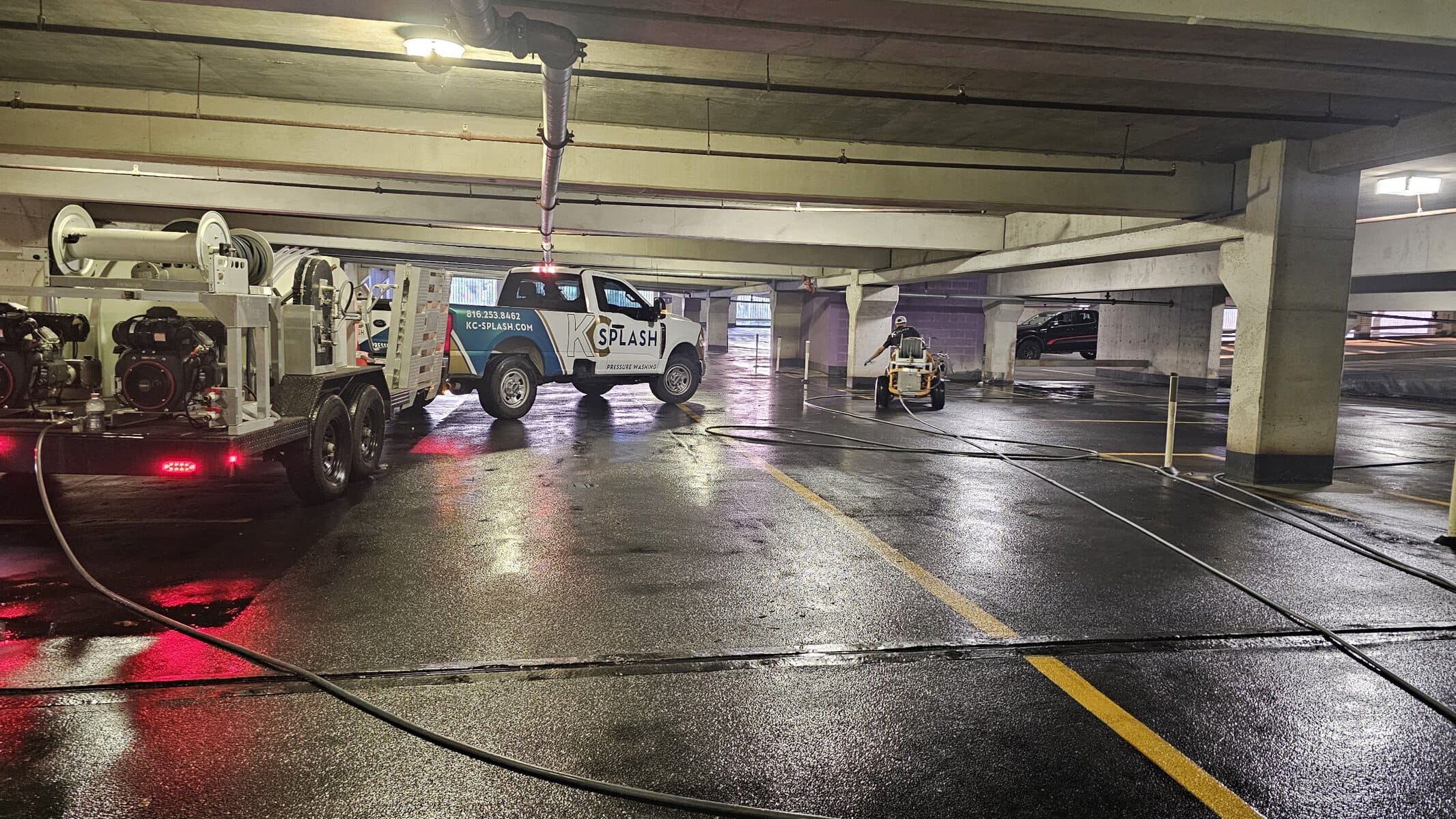 KC Splash ride-on floor scrubber clearing a level at Crown Center parking garage Kansas City