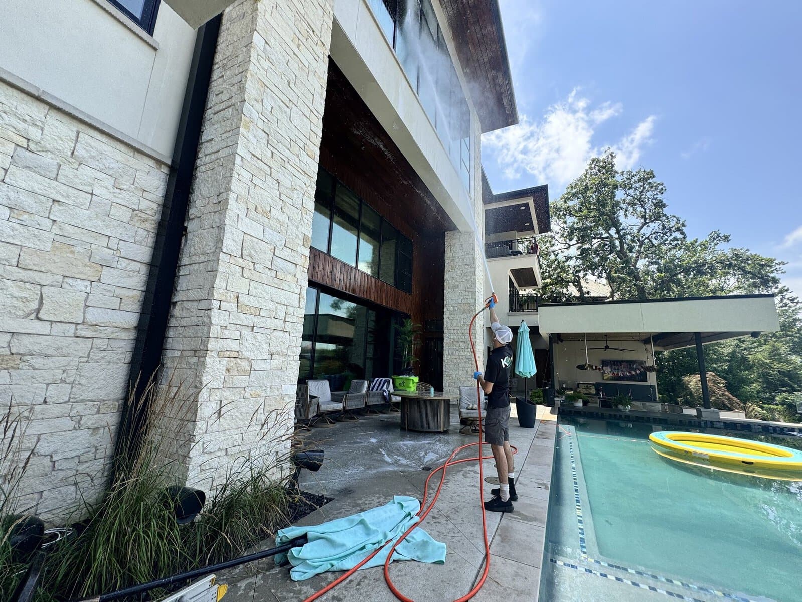 KC Splash house washing the rear of a modern estate over the pool at Weatherby Lake, Kansas City