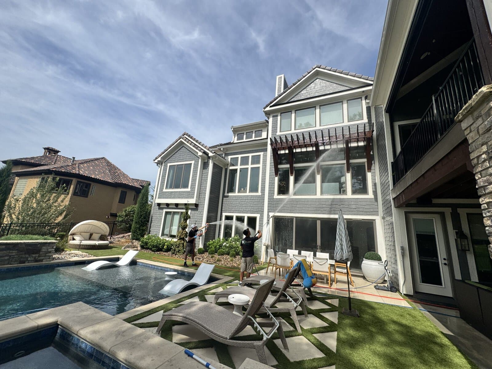 Pool-side rear view of a luxury shingle-style estate soft washed by KC Splash in Kansas City's Northland