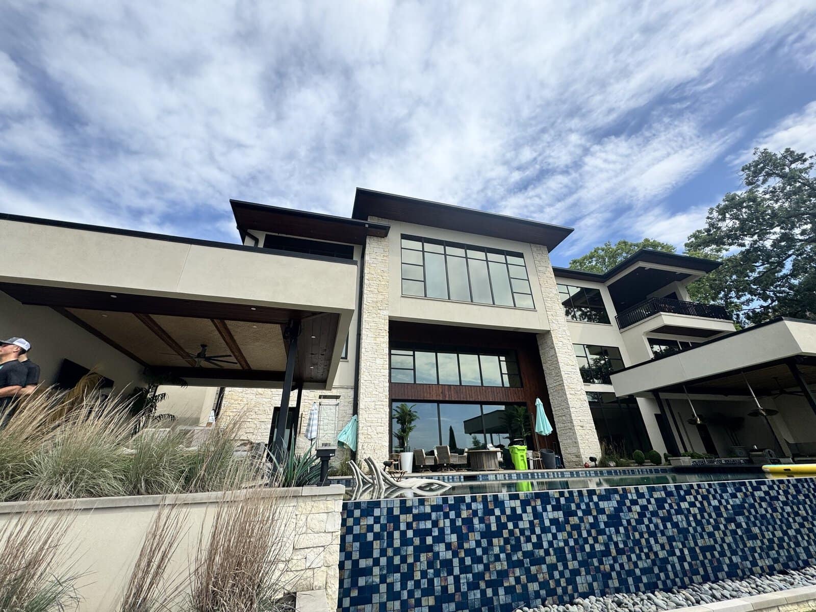 Clean rear elevation of a modern glass-and-stone lakefront estate on Weatherby Lake after KC Splash soft wash
