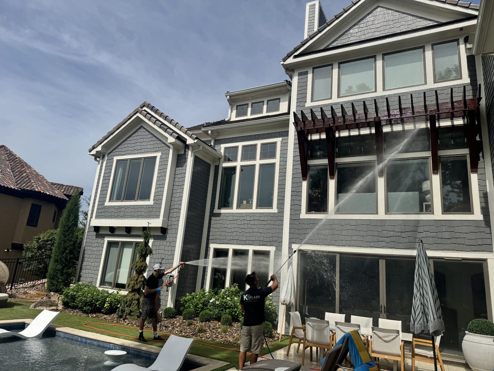KC Splash protecting landscaping and flower beds while soft washing a Northland luxury home