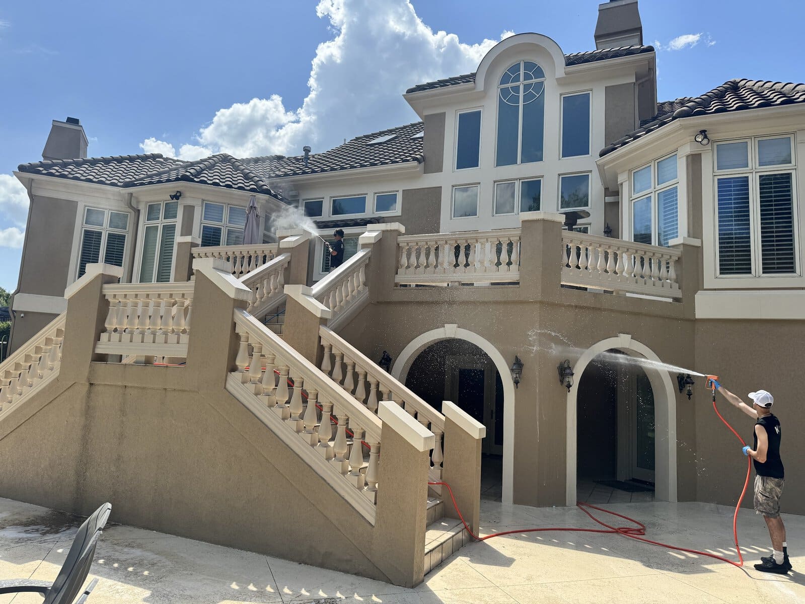 Stucco house washing on balustrade staircase at Parkville luxury estate KC Splash